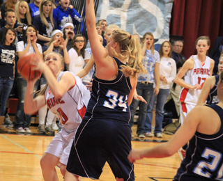 Kendall Schumacher looks to put up a shot past Grangevilles Taylor Canaday.