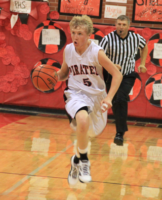 Marcus Higgins brings the ball upcourt against Grangeville.