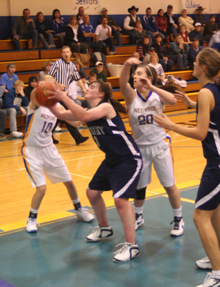 Nicole Frei grabs a rebound in Summits game at Nezperce as Savanah Prigge looks on. Photo by Steve Wherry.