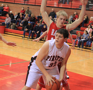 Josh Zigler looks to pass the ball after collecting a rebound.