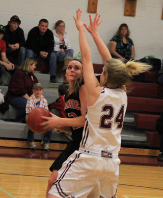 MeShel Rad tries to get a shot up against Kamiah's Shelby Cloninger.