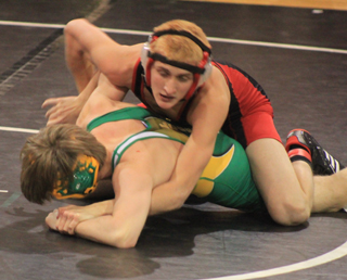 Tayler Heitman tries to turn Potlatchs Todd Marshall.