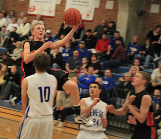 Marcus Higgins goes for a lay-up as a Genesee defender tries (unsuccessfully) to draw a charge. At right is Lucas Arnzen.