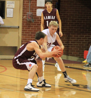 Marcus Higgins and a Kamiah player battle for possession of the ball.