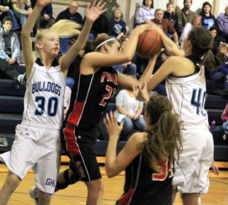 MeShel Rad battles for one of her 21 rebounds against Grangeville as Shelby VonBargen watches.