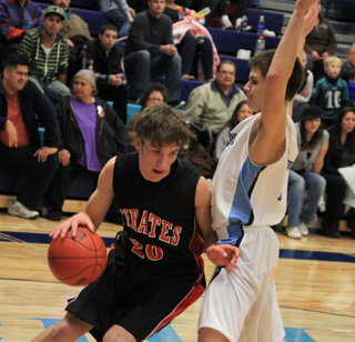 Justin Schmidt drives past a Lapwai defender along the baseline.