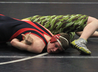 Kade Perrin is about to be awarded a pin against a Potlatch wrestler at the Kamiah Tournament.