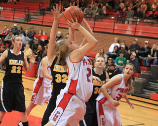 Kendall Schumacher puts up a shot in the Highland game. At right is Shelby VonBargen.