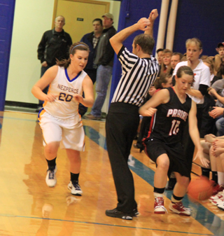 The referee sets an inadvertent pick for Megan Sigler, who came very close to stepping out of bounds, after she stole the ball. She wound up driving downcourt for a lay-up.