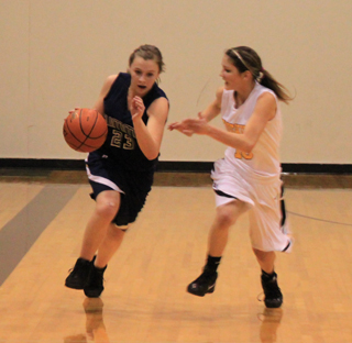 Brooke Schumacher brings the ball downcourt against Highland.