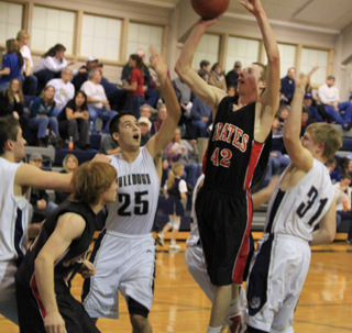 Casey Danly puts up a shot inside against Grangeville. Troy Lorentz is at left.
