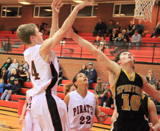 Lucas Arnzen scores 2 of his game-high 18 points against Timberline. Also shown is Tyler Hankerson.
