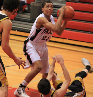After coming up with a loose ball Tyler Hankerson looks to score against Timberline.