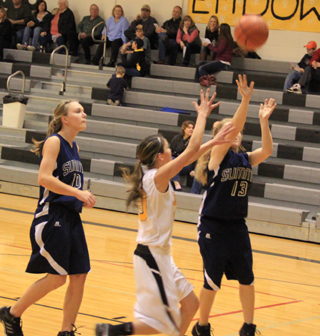 Nicole Wemhoff scores a layup at Highland. At left is Sarah Chmelik.