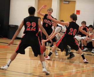 Tyler Hankerson, Marcus Higgins and Justin Schmidt apply full court pressure at Kendrick.