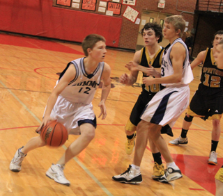 Summits Josh Lustig takes the ball toward the hoop against Timberline as Shane Stubbers sets a screen.