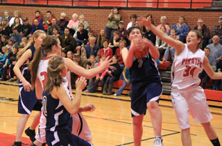 Nicole Frei of Summit comes down with a rebound after a missed Prairie shot. Others from left are Kayla Schumacher and Sarah Chmelik of Summit and MeShel Rad and Shelby VonBargen of Prairie.