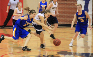 Summits Sarah Chmelik and a Nezperce player go after a loose ball. In the background are Nicole Wemhoff, left and Kayla Schumacher.