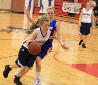 Nicole Wemhoff drives past a Nezperce defender. In the background is Brooke Schumacher.