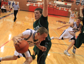 Derek Nuxoll tries to get past a Potlatch defender. At right is Josh Lustig.