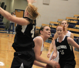 MeShel Rad slips past a Deary defender as she goes for a lay-up. In the background is Tanna Schlader.