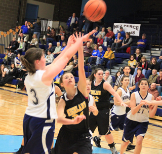 Nicole Frei shoots against Highland at District. Also shown are Kayla Duclos and Megan Seubert.