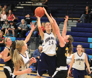 There was an excellent chance this shot went in as Savanah Prigge connected on 11 of 12 attempts in Summits district opener against Highland. Also shown are Kayla Schumacher, left, and Rachael Frei.