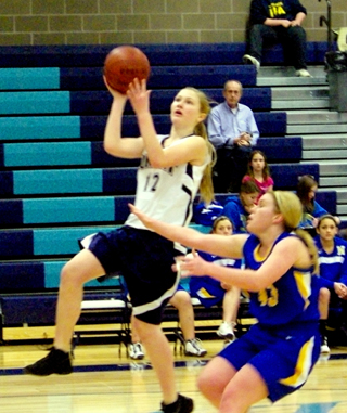 Kayla Schumacher goes for a layup in the District championship game. Photo by Alyssa Frei.