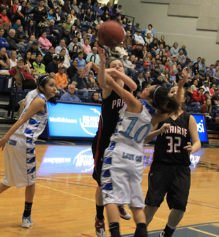 MaKayla Schaeffer gets hacked across the arm as she tries to shoot. At right is Taylor Heitman.