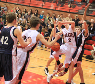Summit defenders knocked the ball loose from Rhett Schlader on this shot attempt but the ball wound up going right to Justin Schmidt, 20, who scored a lay-up. Summit players shown from left are Matthew Schwartz, 42, Michael Waters, Josh Lustig and David Waters.
