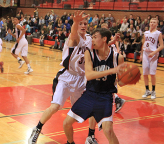 Prairies Lucas Arnzen guards Summits David Waters after Waters made a rebound. At left heading downcourt is Tyler Hankerson. At right is Marcus Higgins.