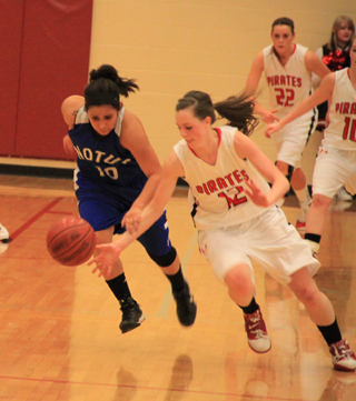 MaKayla Schaeffer steals the ball from Notus. In the back are MeShel Rad and Megan Sigler.