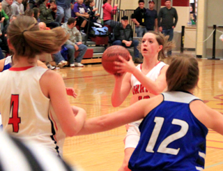 Megan Sigler lines up a shot against Notus. In the foreground is Tanna Schlader.