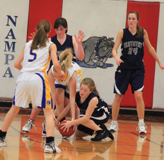 Nicole Wemhoff goes after a loose ball in the Carey game as Nicole Frei and Savanah Prigge watch.