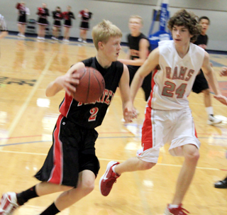 Rhett Schlader drives past a C.V. defender at District. In the background are Marcus Higgins and Tyler Hankerson.