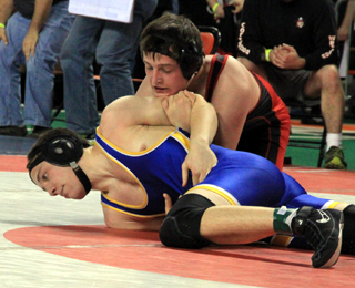 Garrett Schmidt tries to turn Riries Kaleb Orchard in the match that clinched a state medal.