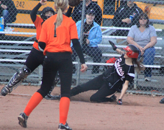 Savanah Prigge slides home with Prairies first run of the season, scoring from third on a groundout to first by Tanna Schlader.