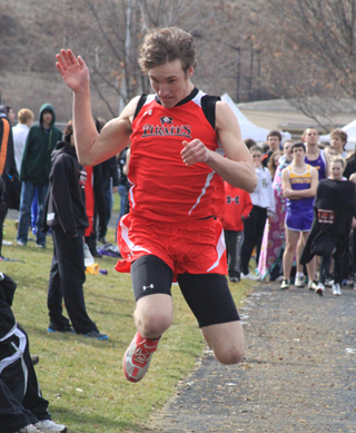 Justin Schmidt soars towards the pit in the triple jump where he took first place.