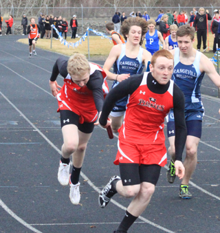 Marcus Higgins dives to make the handoff to Troy Lorentz in the 4x200 relay. Prairie wound up winning by .01 seconds.