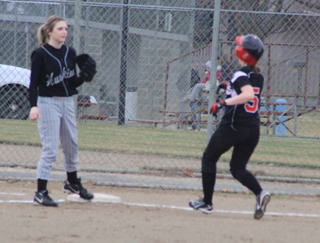 Megan Sigler pulls into third with a leadoff triple.