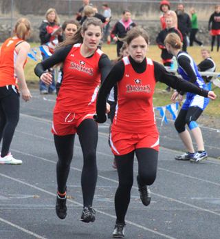 Shelby VonBargen hands off to Claire Whitley in the 4x200 relay.