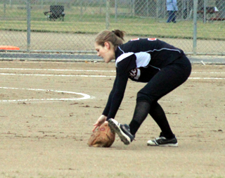 Tanna Schlader fields a grounder at second base and is about to turn it into a putout at first base.
