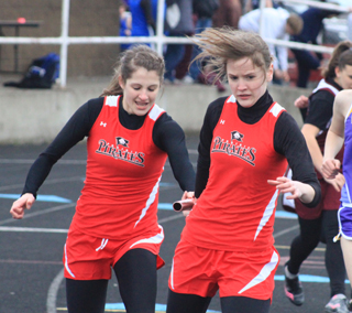 Shelby VonBargen makes a handoff to Claire Whitley in the 4x200 relay.