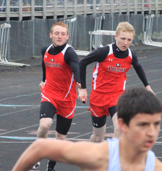 Later in the same relay started by Dakota Wilson at left, Troy Lorentz hands off to Marcus Higgins.