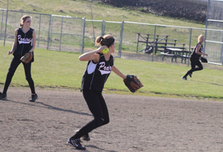 Leah Holthaus had a busy game at shortstop against Grangeville handling 7 chances without an error. At left is Andrea Kaschmitter while at right Kelsey Tidwell looks to back up the play at first.