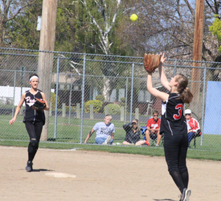 Tanna Schlader is about to catch a popup in the first Troy game as Leah Holthaus watches.