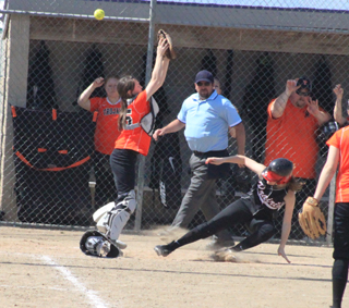 Tanna Schlader slides into home as the throw goes over the catcher's head.