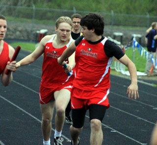 Torin Dalgliesh hands off to Cody Schumacher in the medley relay.