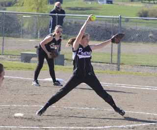 Megan Sigler winds for a pitch as first baseman Kendall Schumacher gets ready for a possible play.
