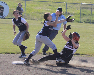 Megan Sigler slides safely into second base with a stolen base as the throw comes in a little too high to catch her.